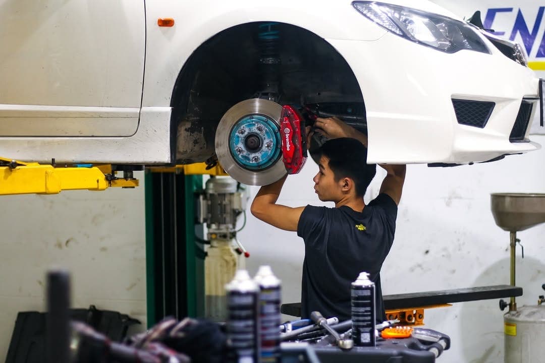 Technician fitting brakes