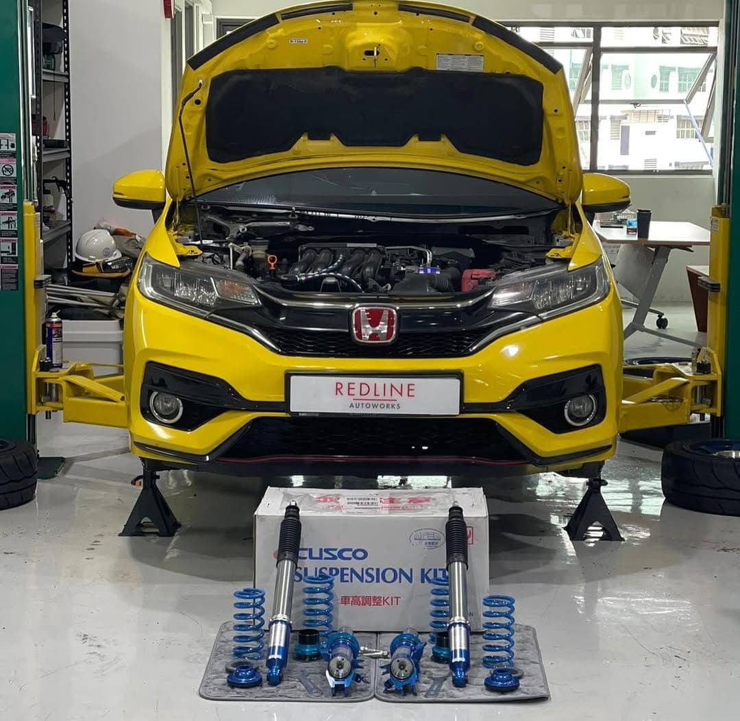 Yellow Honda Fit with Cusco suspension kit