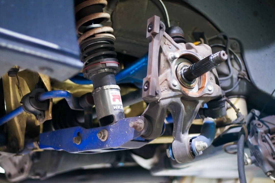 Suspension and brake assembly under a car